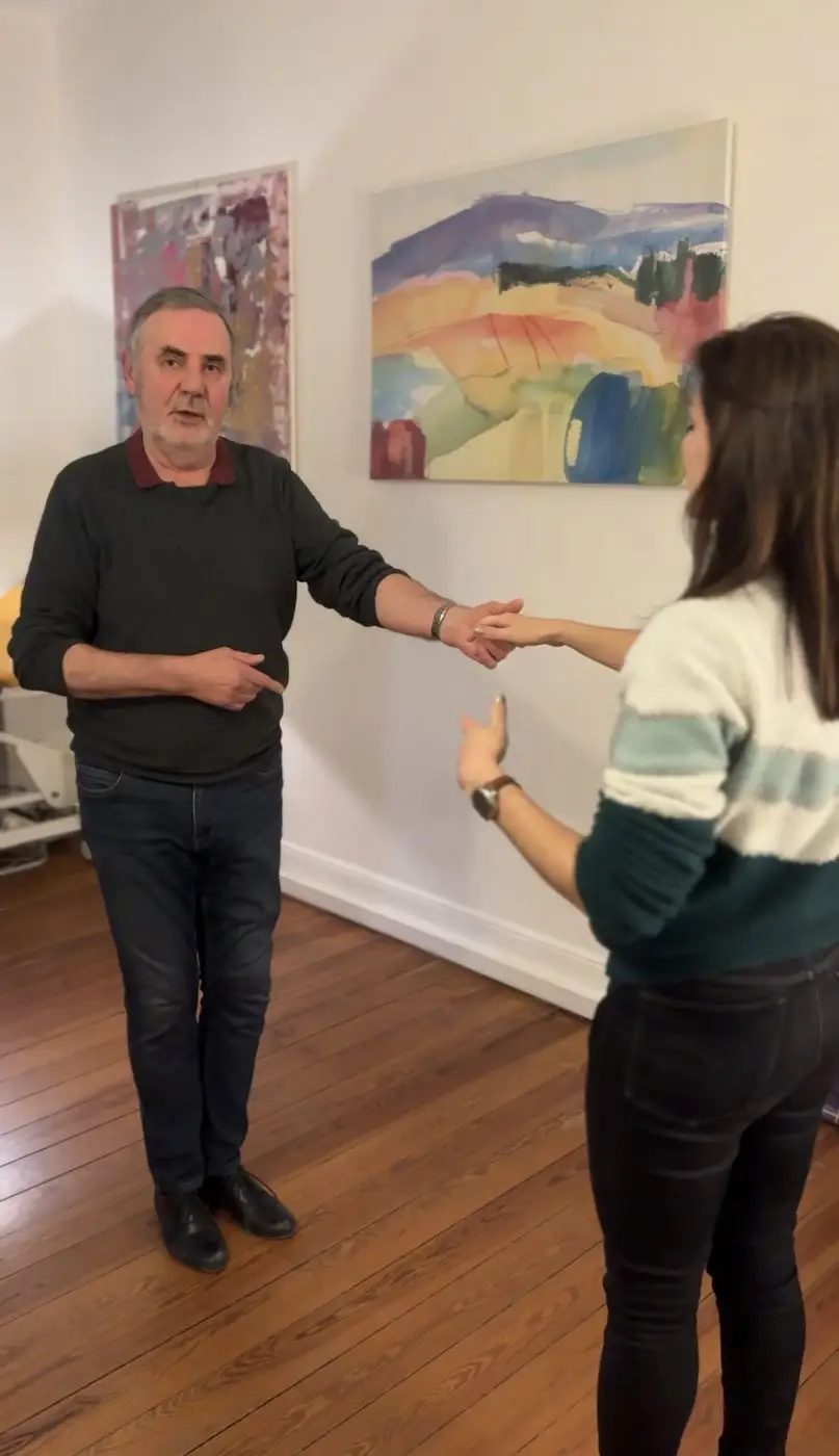 Francis montre un guidage bras tendu à une élève pendant un cours particulier